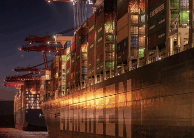 Shipping containers in the ocean at night.